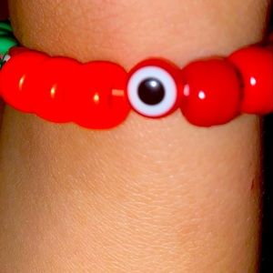 Evil eye Orange red and green bracelet.
